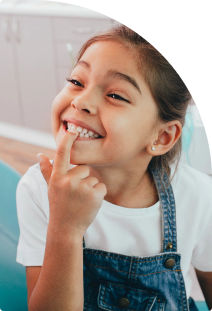 Child pointing her white teeth