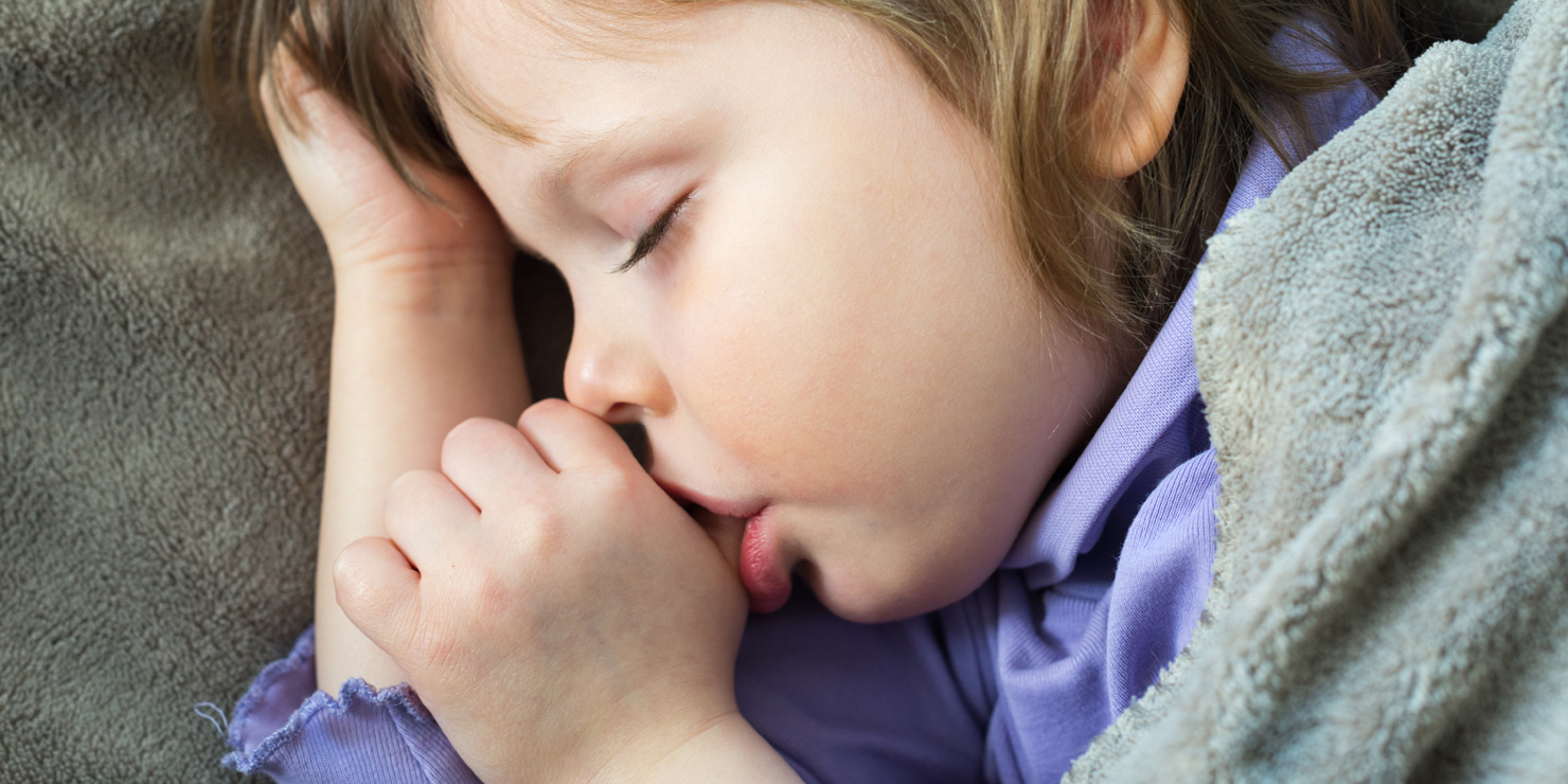 Sleeping little cute baby sucking