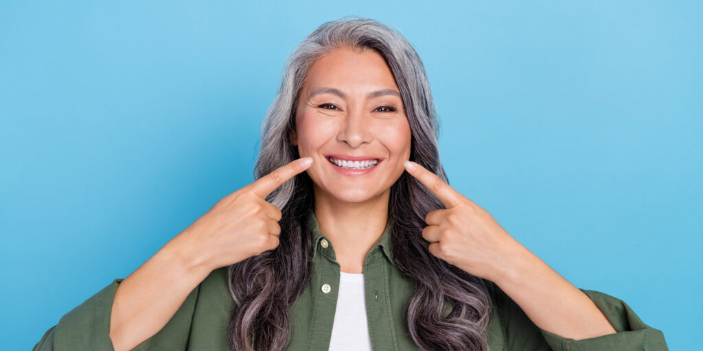 aged lady showing beautiful smile teeth