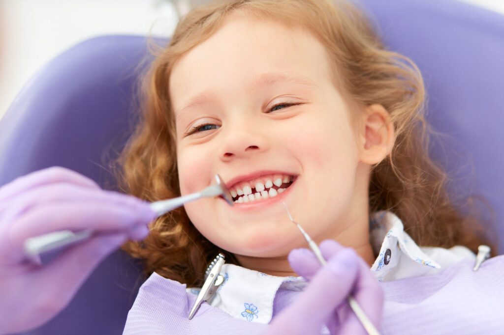 Smiling girl during a pediatric dental exam